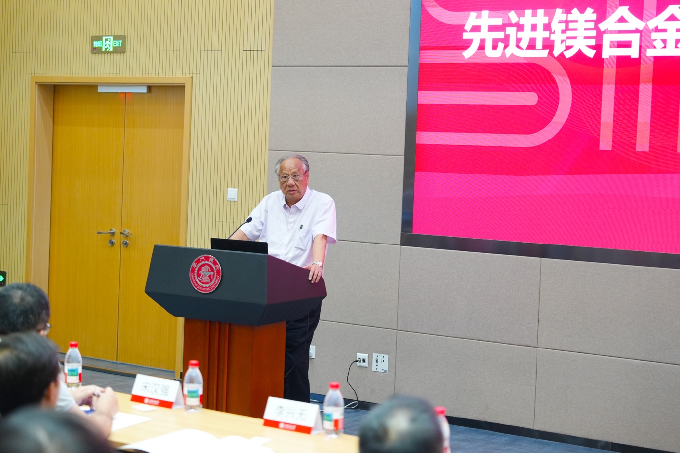 A person standing at a podium
Description automatically generated